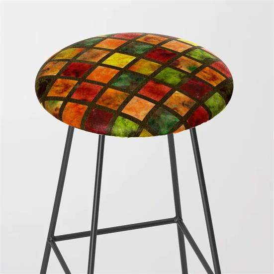A metal legged bar stool feauring the Autumn Leaf Brown quilt design on the seat.