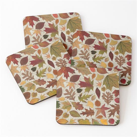 A set of 4 coasters featuring a design of autumn leaves on a tan speckled background.
