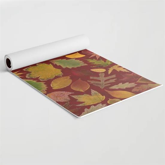A foam yoga mat featuring the Autumn Leaves Red design on the top.