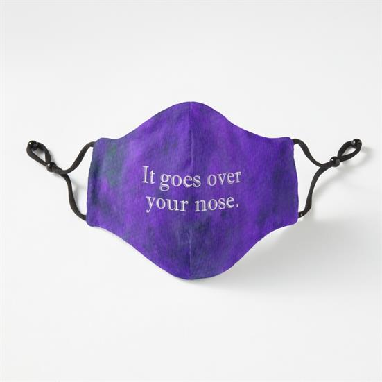 A cloth face mask with adjustable elastics, with white text that says, "It goes over your nose." on a purple and blue mottled background.