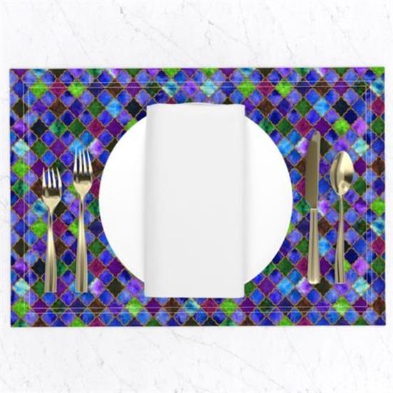 A placemat in an arabesque design featuring blues, greens, and purple.