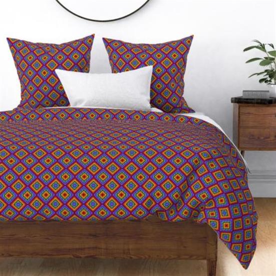 A duvet cover and shams featuring a rainbow diamond quilted pattern.