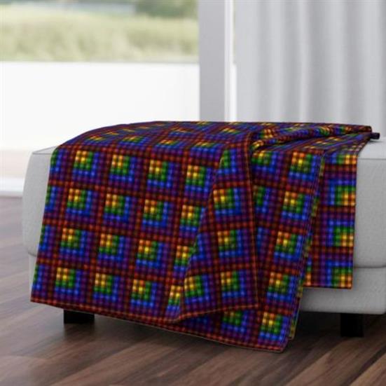 A throw blanket featuring a rainbow plaid design.