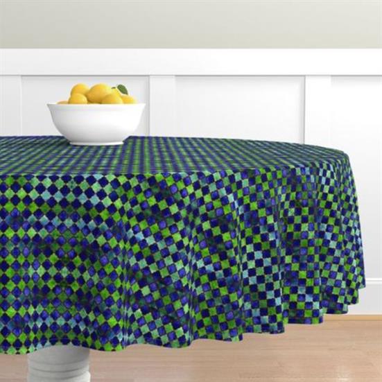 A table cloth in an arabesque design featuring blue, green, and hints of red.